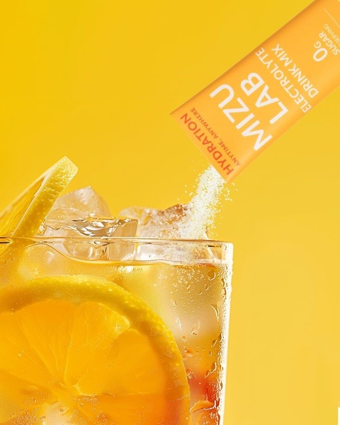 A high-contrast, bright yellow ad creative showcasing an electrolyte drink mix packet pouring granules into a glass of ice water with a fresh lemon slice.